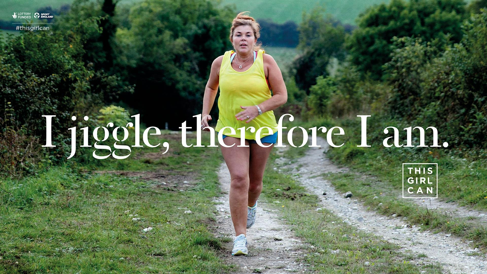 A woman jogging on a rural path with the motivational phrase "I jiggle, therefore I am." displayed, part of the "This Girl Can" campaign.